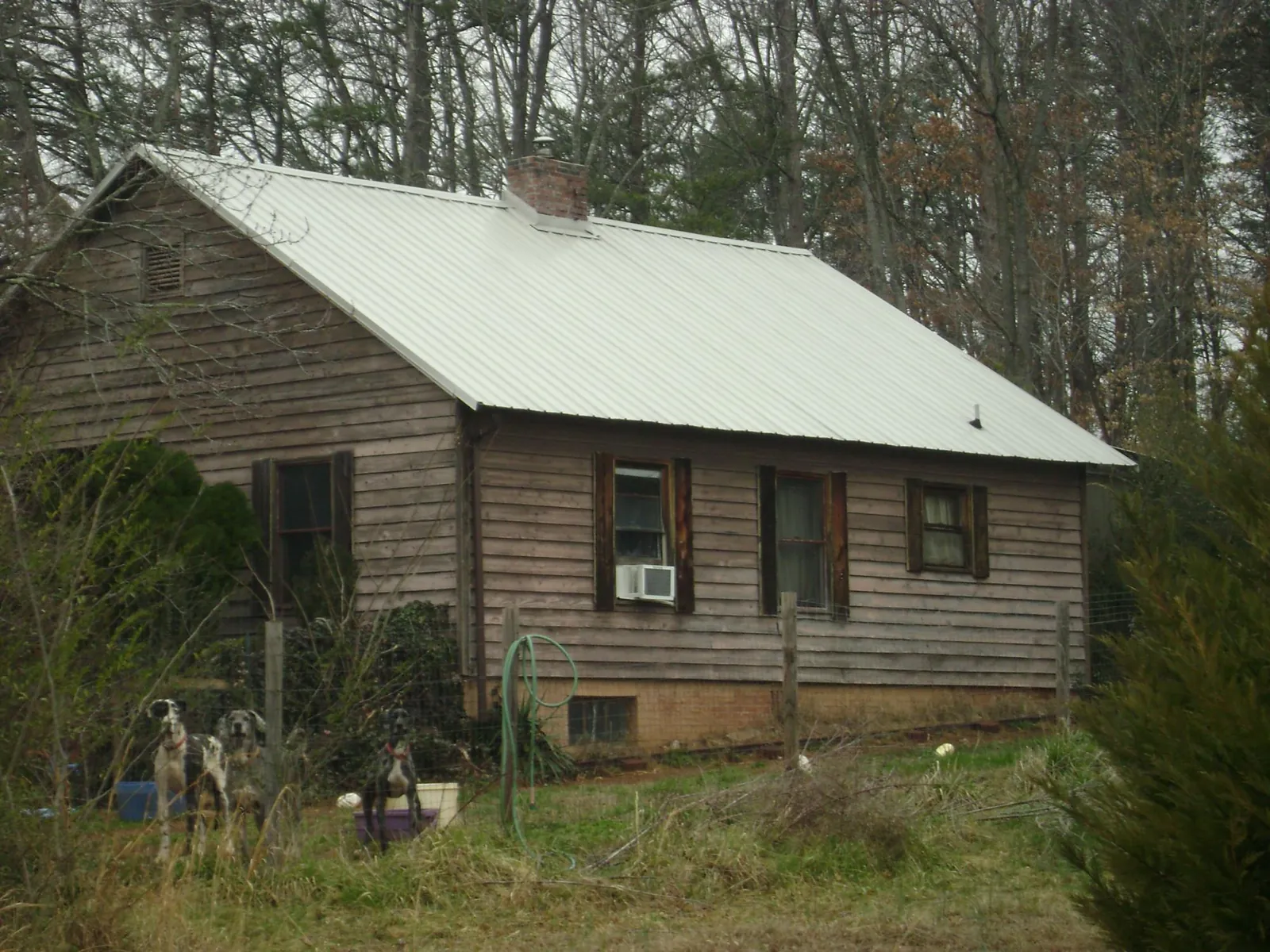 White metal roof on an old wood sided farmhouse, from a Asphalt Shingle Roof Repair job in Kanawha